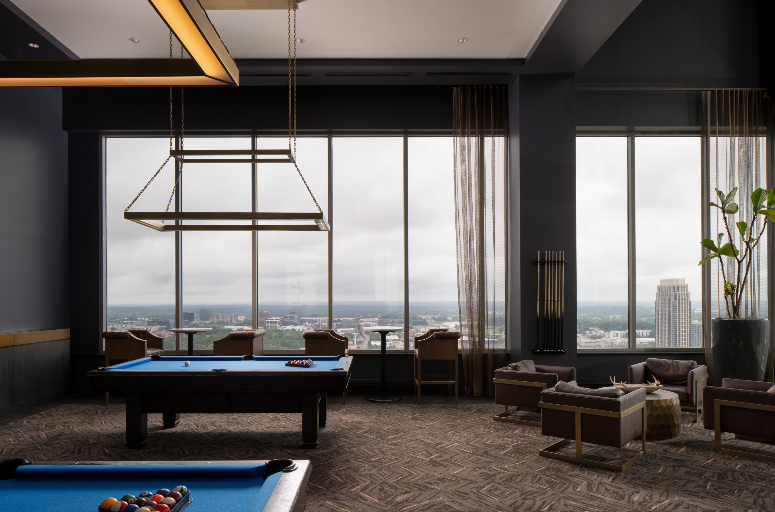 High-rise club room with pool tables in The Hue Midtown luxury apartments in Atlanta, GA