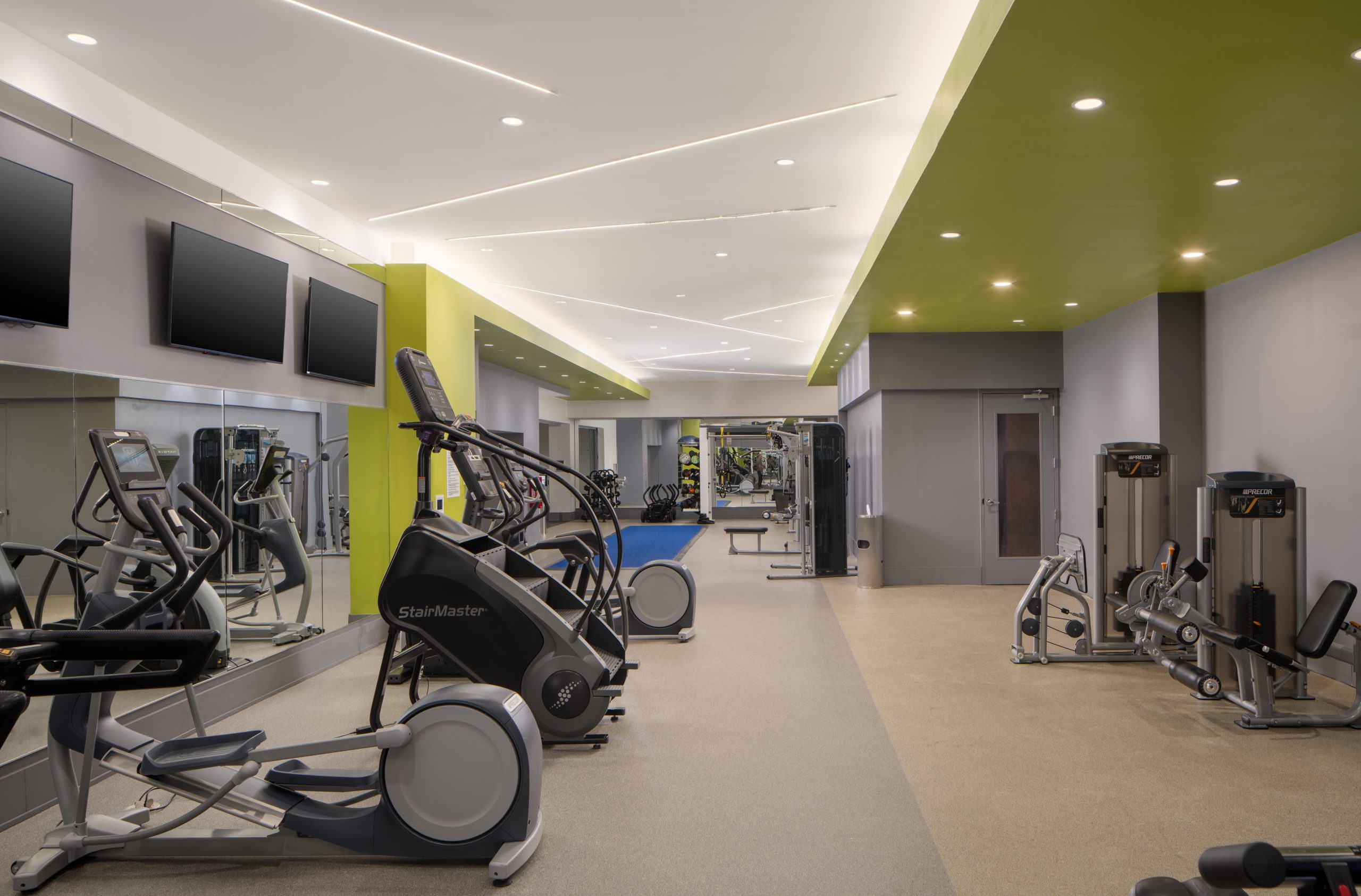 Fitness center featuring exercise machines at The Hue Midtown luxury apartments